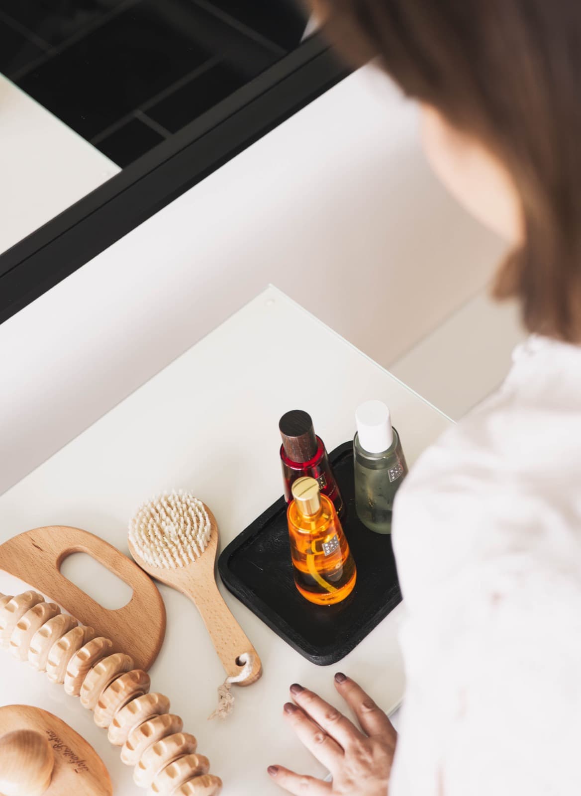 Wooden massage tools and treatment oils laid out at Relax Revive Beauty